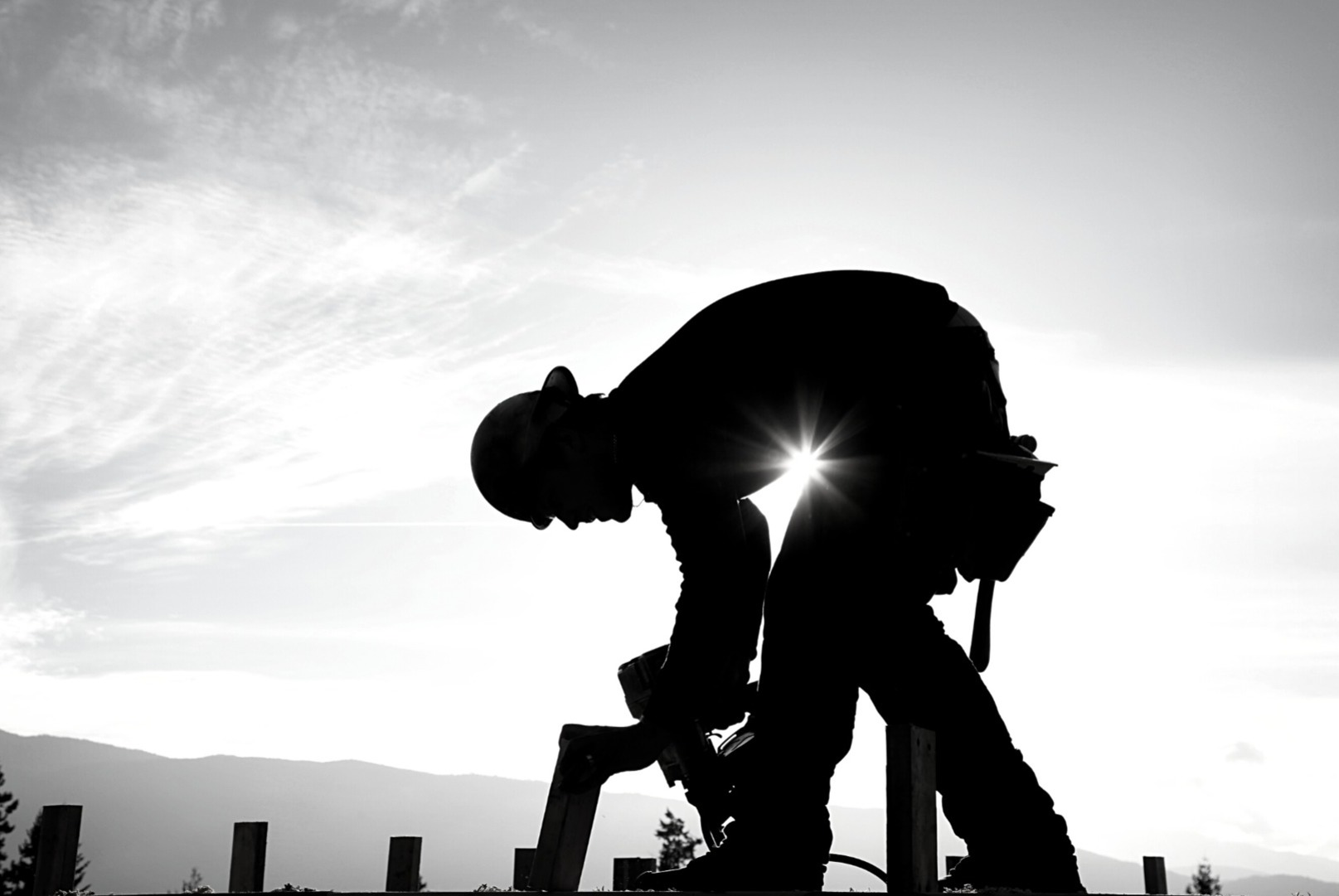 Silhouette of subcontractor using grinder